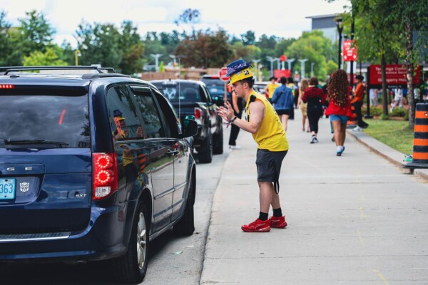 Cars dropping off students on their first day attending university.