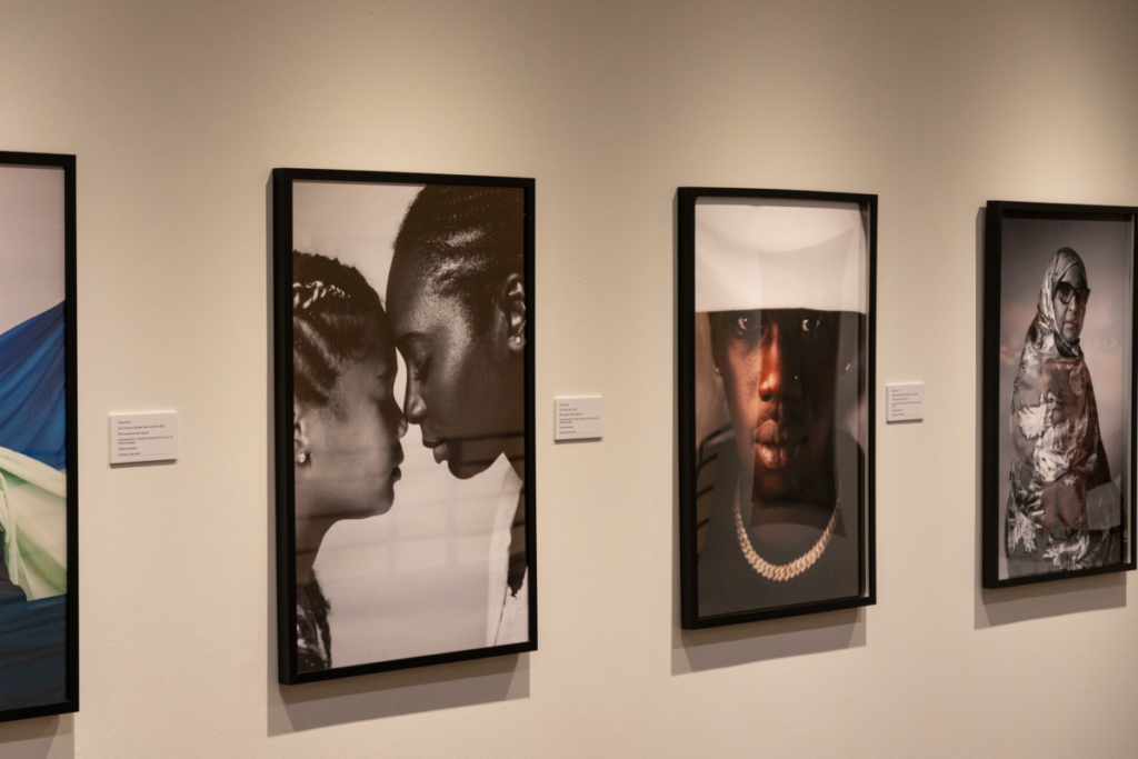 Portraits hang on a white wall from at Omer's exhibit at the Carleton University Art Gallery.