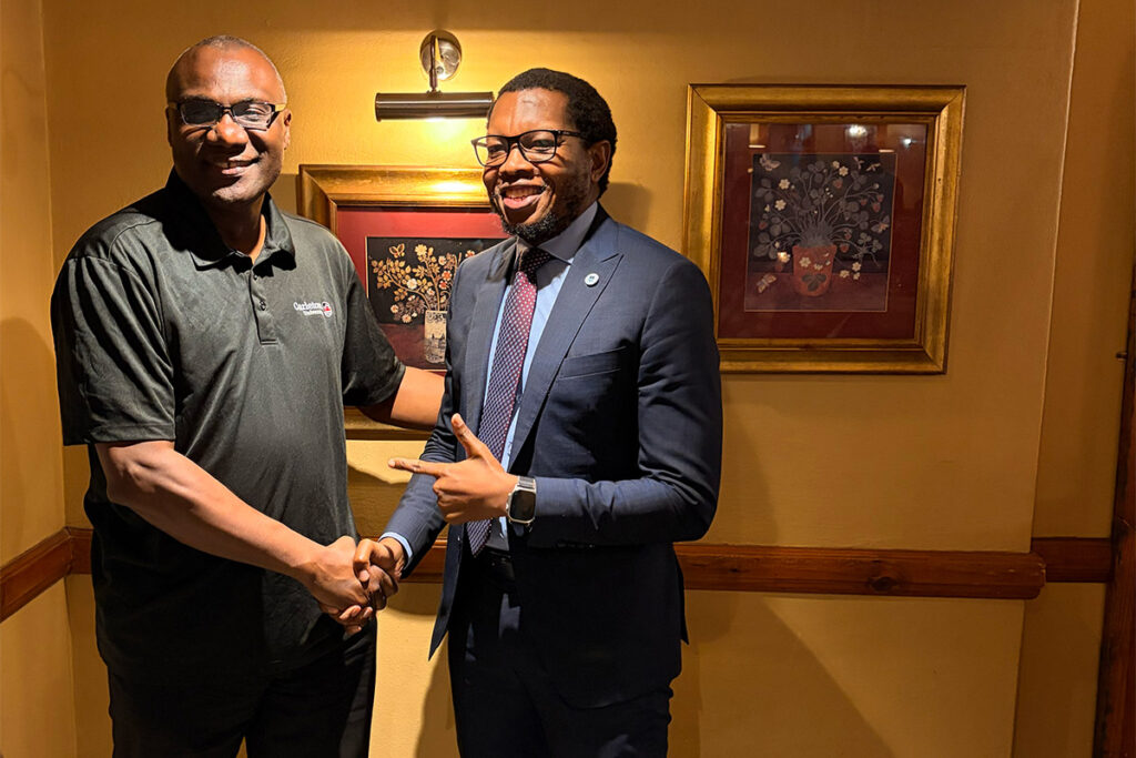 Wisdom Tettey shakes hands with a university representative during the South Africa visit.