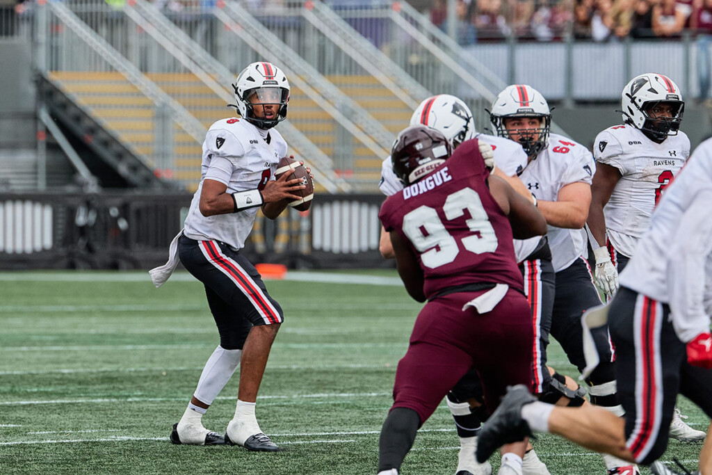 A Carleton Ravens quarterback prepares to pass against the Ottawa Gee-Gees.