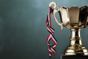 A trophy and ribbon are displayed.