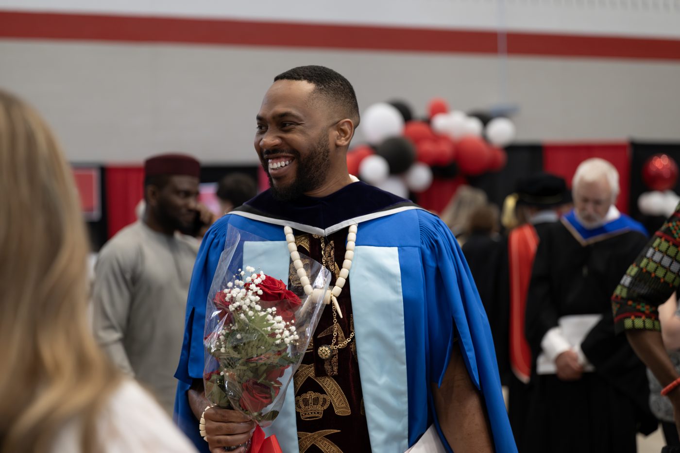 A recent graduate smiles after convocation.