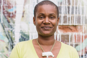 Annamie Paul outdoors in an urban setting, smiling at the camera