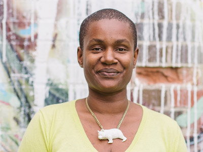 Annamie Paul outdoors in an urban setting, smiling at the camera