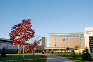 Trees line the pathway leading to Carleton's Athletics building.