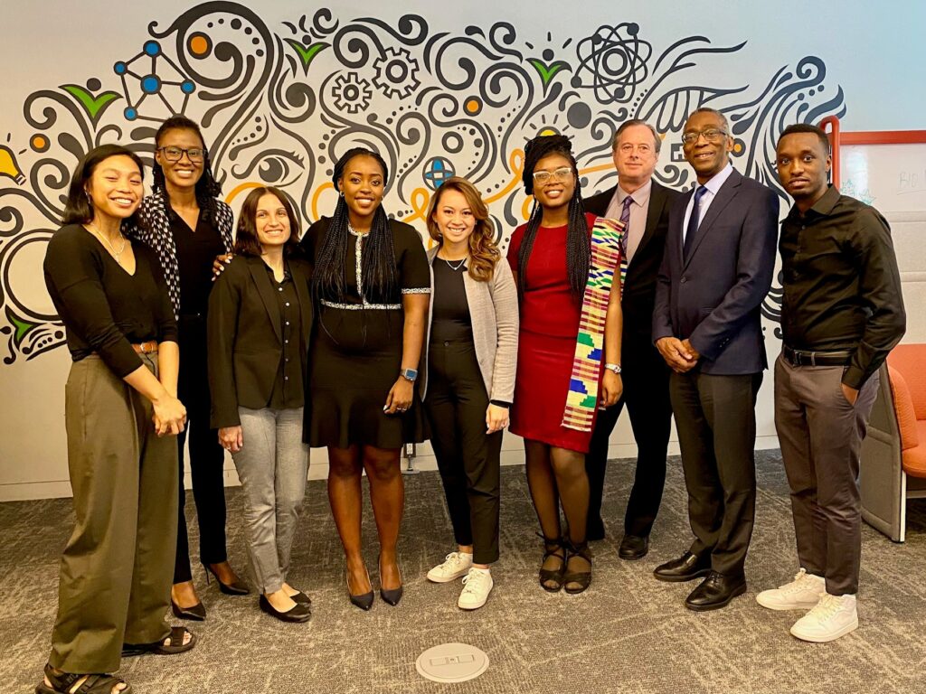 A large group of professionally dressed people pose for a photo.