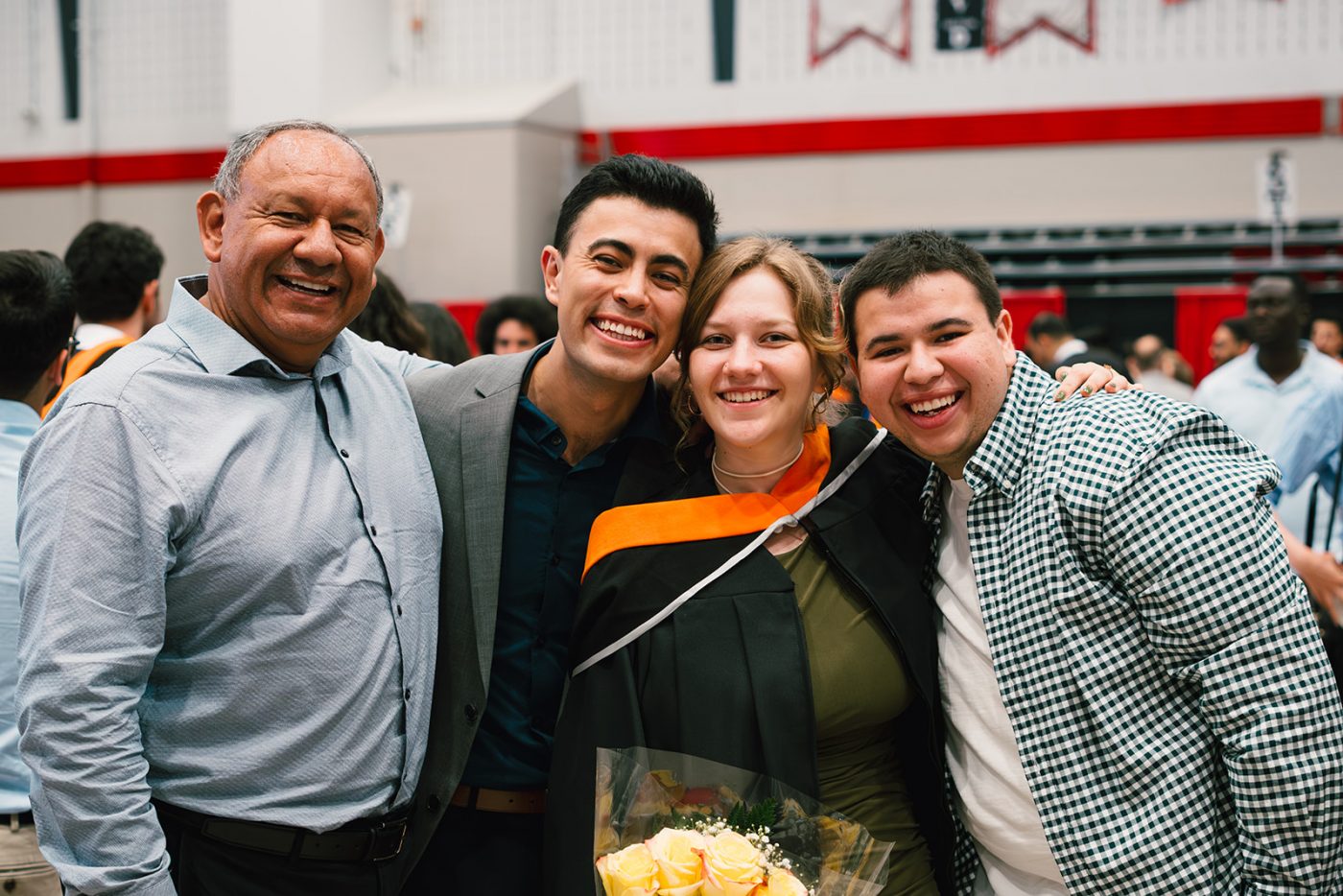 A recent graduate and her supporters smile for a photo in the Ravens Nest.