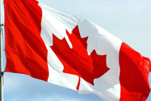 A Canadian flag waves in the wind.