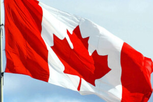 A Canadian flag waves in the wind.