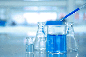 A photo of scientific beakers containing liquid in a lab.