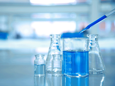 A photo of scientific beakers containing liquid in a lab.