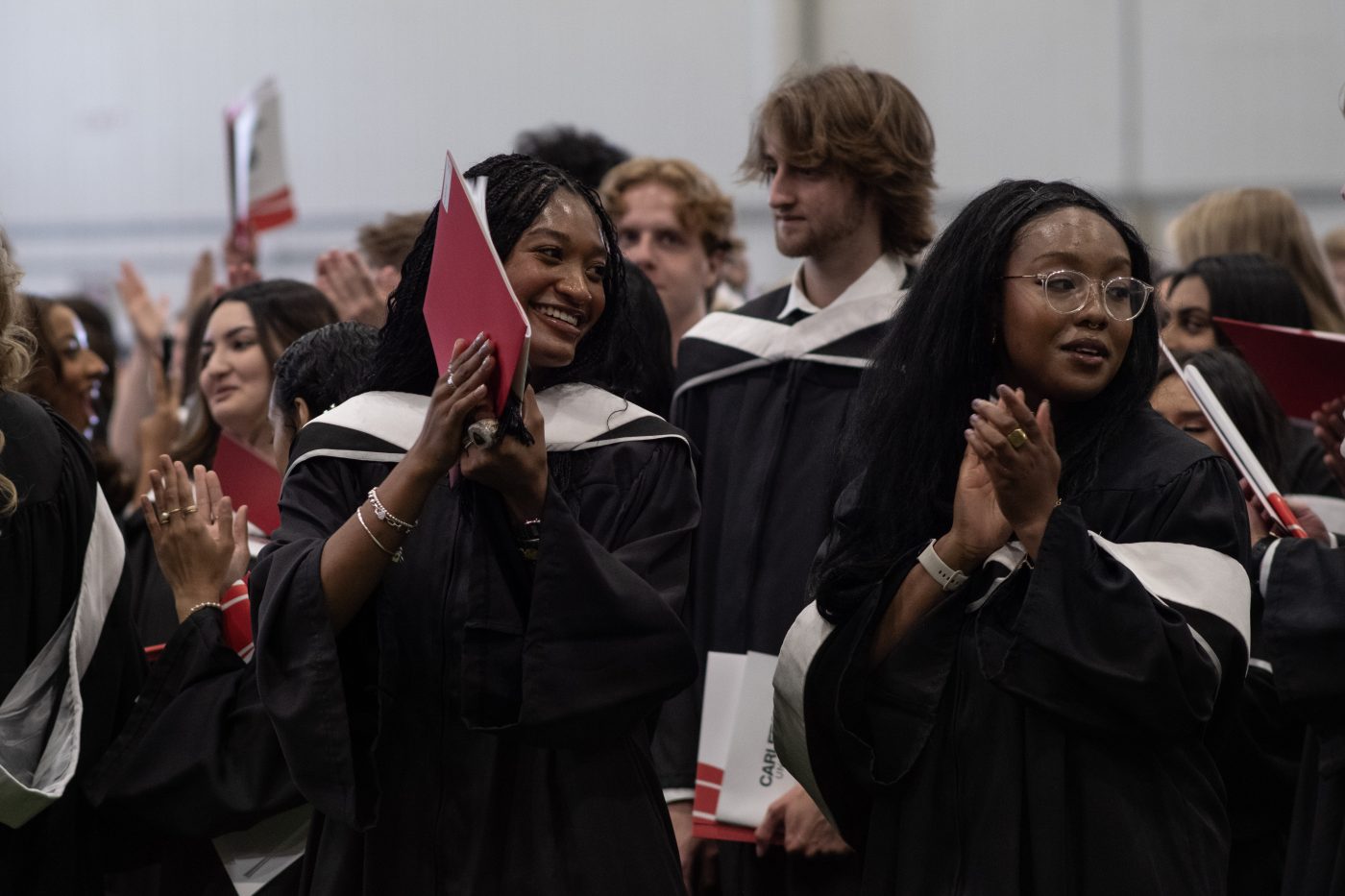 Students applaud at a convocation ceremony.