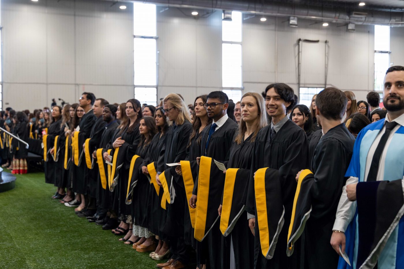Students wait to cross the stage at their convocation ceremony.