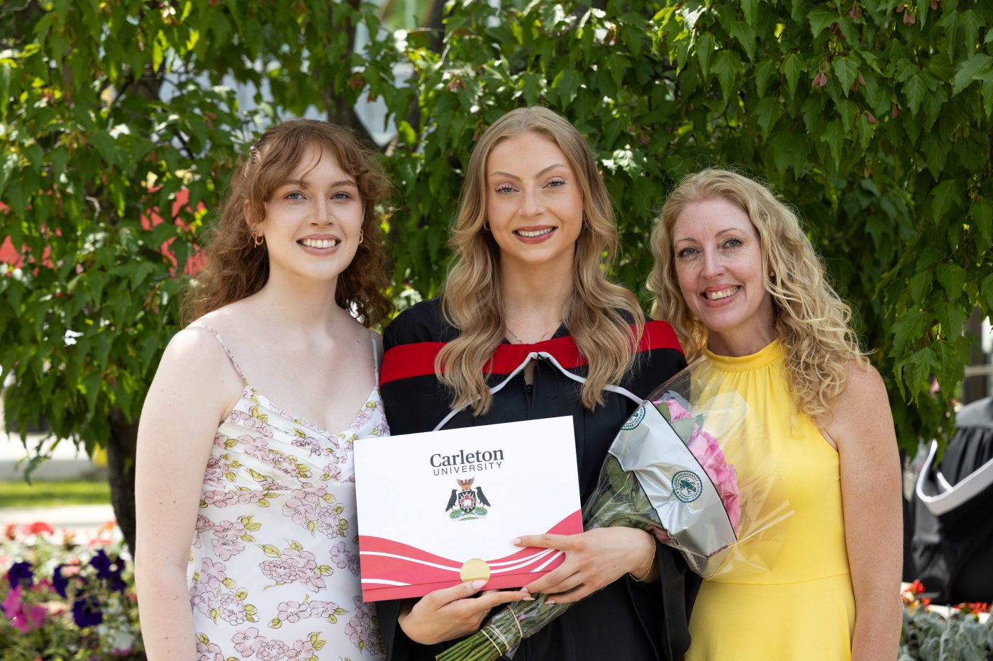 A graduating student and her supporters take a photo following a convocation celebration.