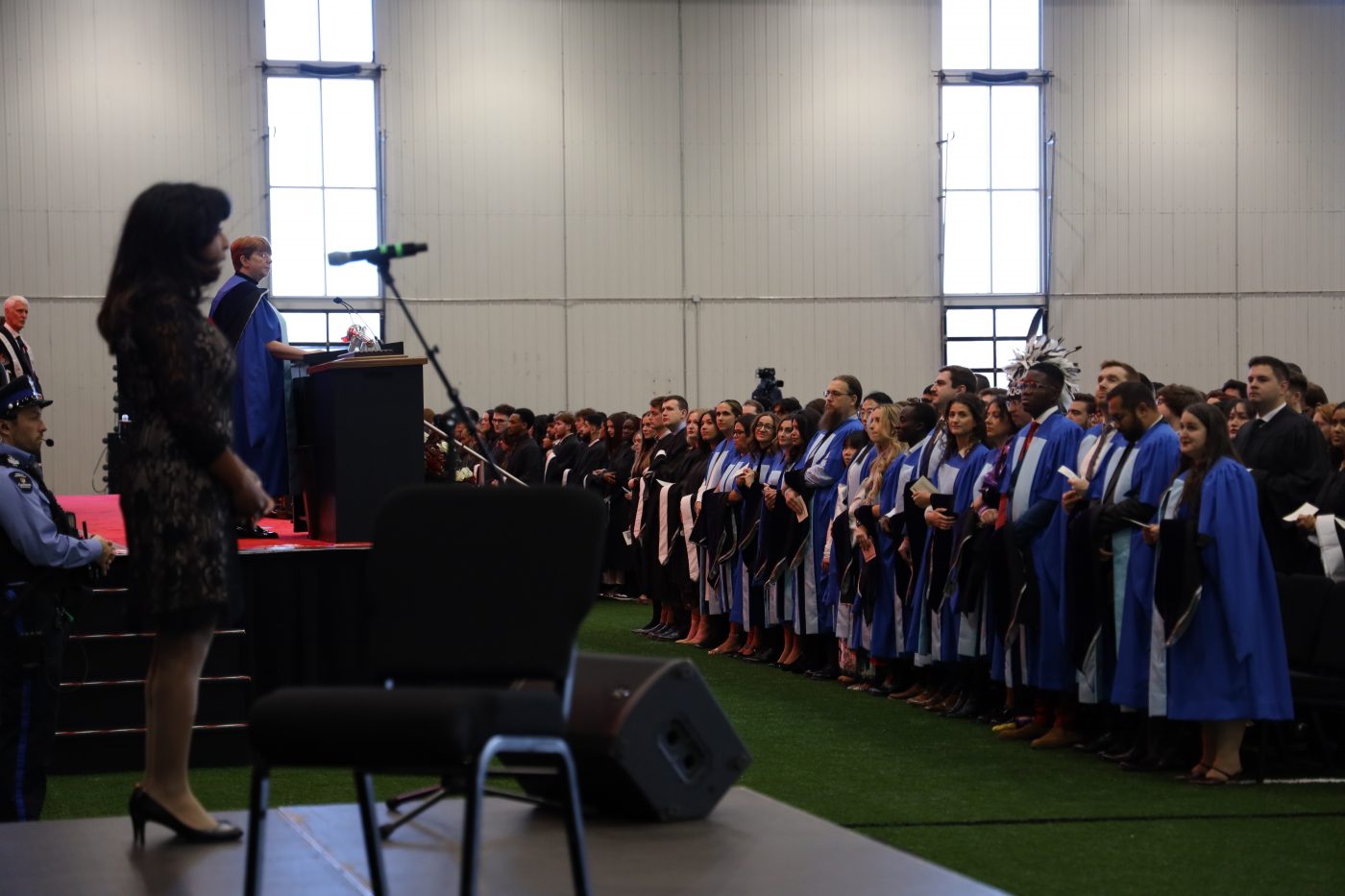 A speaker addresses the audience at a convocation ceremony.