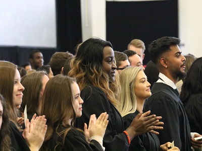 Graduates applaud during fall convocation.
