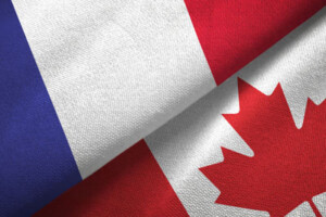 The flags of France and Canada are folded side by side.