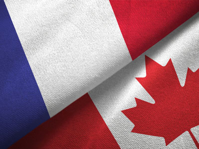 The flags of France and Canada are folded side by side.