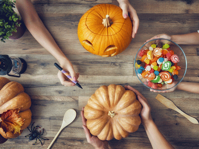 A photo of pumpkins and Halloween candy.