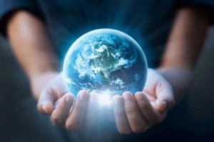 A pair of hands hold the earth.