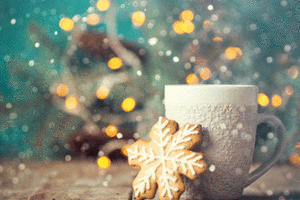 An image of a cookie in the shape of a snowflake and a mug.