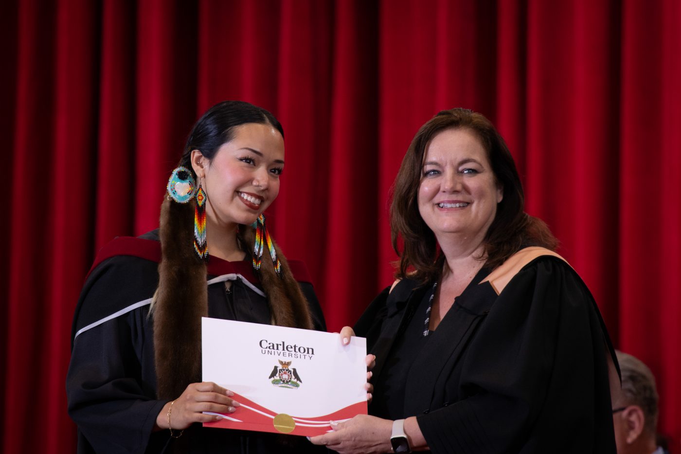 A student receives her degree at convocation.