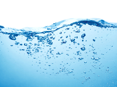 A wave of water contains bubbles under the surface.