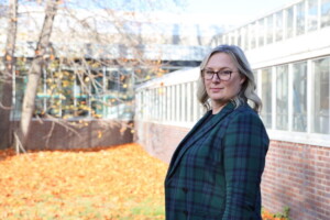 Jessica Davis stands to the side in front of a building.
