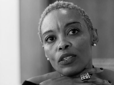 A photo of author Kagiso Molope, she is resting her chin on her hands.