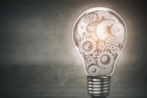 A picture of a lightbulb filled with mechanical pieces.