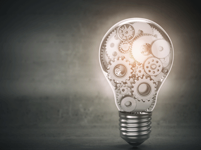 A picture of a lightbulb filled with mechanical pieces.