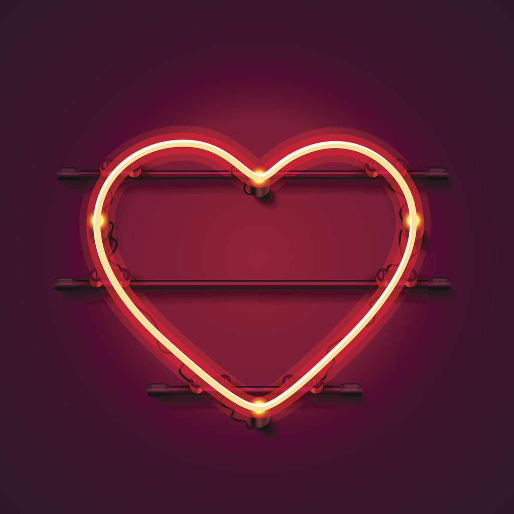 Neon heart signboard on the red background.