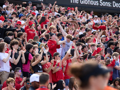Crowds cheering while wearing Carleton swag at the Panda match.