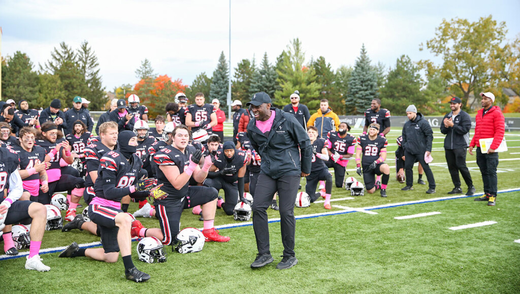 Corey on the football field encouraging the team before the game.