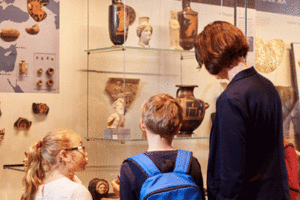 Visitors look at a museum display.
