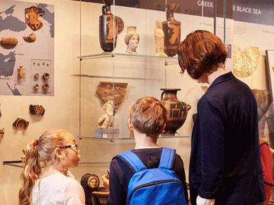 Visitors look at a museum display.
