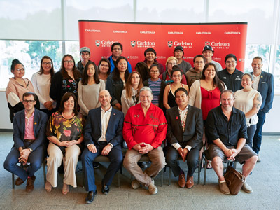 A group of youth from the Youth of Nishnawbe Aski Nation poses together with Carleton and NAN representatives in Richcraft Hall.