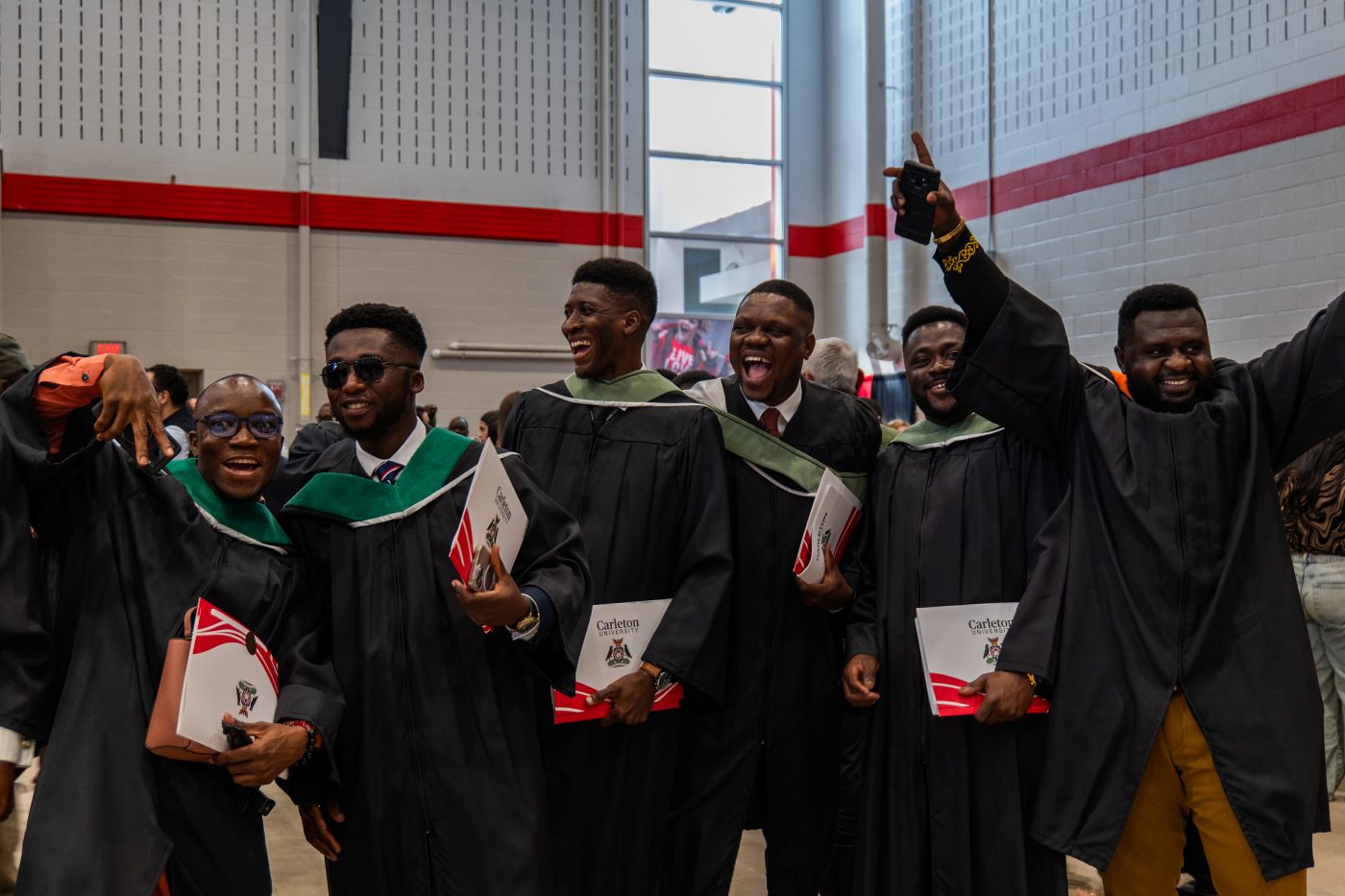 Students celebrate in the Ravens Nest after receiving their cu_people_degree