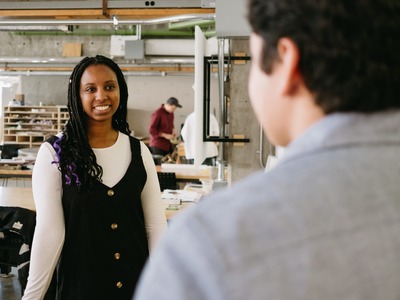 Two students face each other in a design lab.