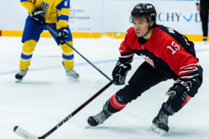 Madoka Suzuki plays hockey against a Ukrainian team.