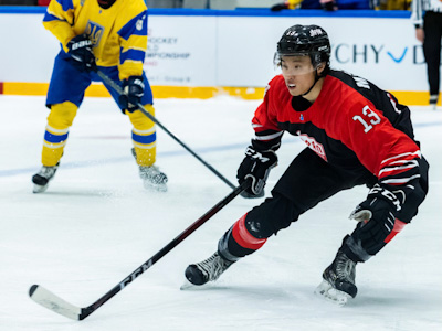 Madoka Suzuki plays hockey against a Ukrainian team.