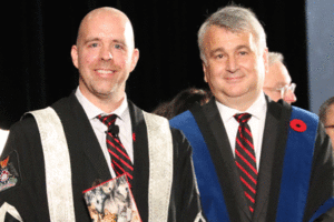 President Bacon stands with Board of Governors Chair Nik Nanos following the swearing of the presidential oath at fall Convocation.