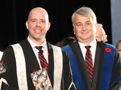President Bacon stands with Board of Governors Chair Nik Nanos following the swearing of the presidential oath at fall Convocation.
