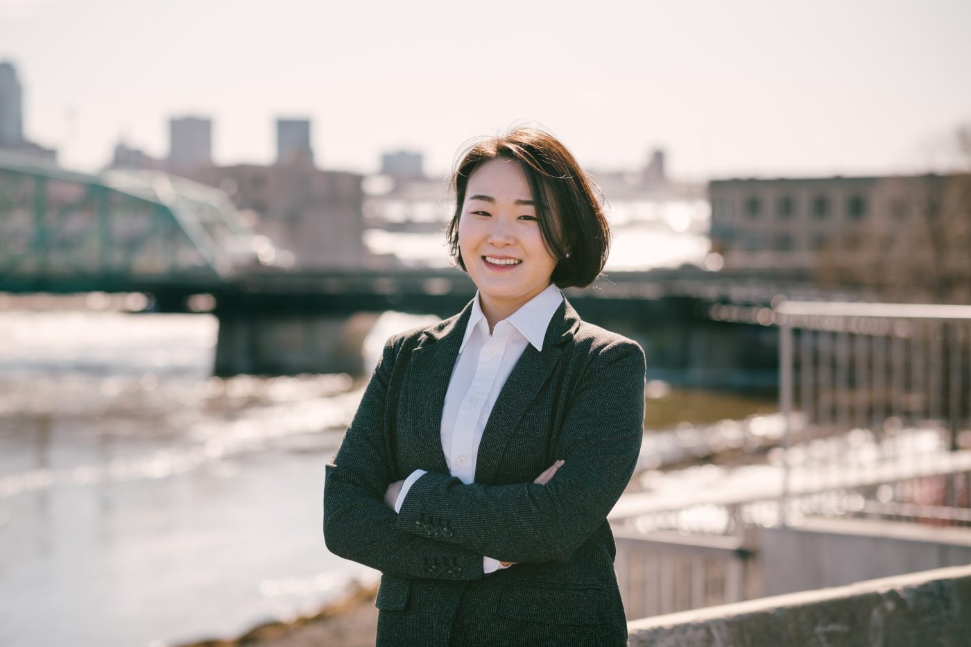 Prof. Yeowon Kim standing on a bridge overlooking the Ottawa River