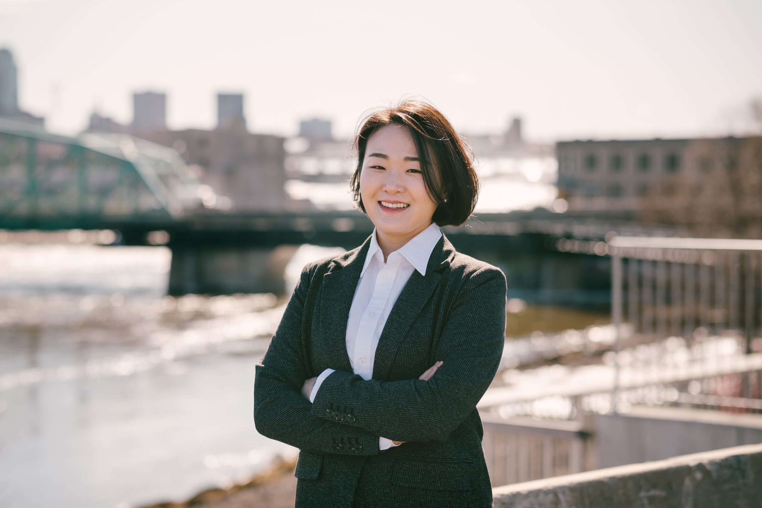 Prof. Yeowon Kim standing on a bridge overlooking the Ottawa River