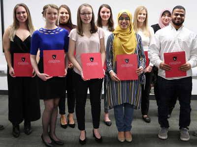 The Provost Scholar Award Recipients hold their awards.