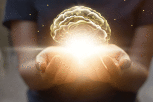 Hands hold an artistic representation of the mind.