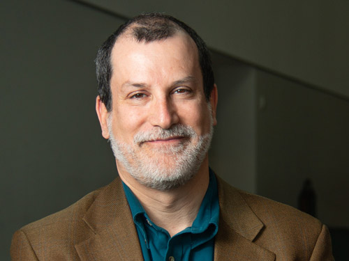 A headshot of Stephen Saideman in a suit jacket.
