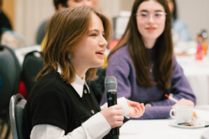 Attendees speak at a STEM conference.