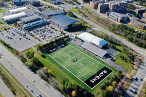 An aerial shot of the Carleton University campus. The football field can be seen with the word Ravens in the end zone.